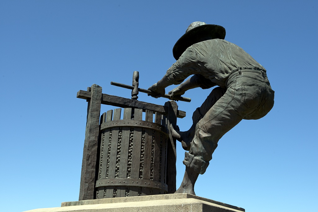 Statue of a worker at a wine press in Napa Valley, California