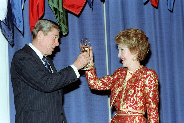 Ronald and Nancy Reagan toasting with a glass of wine